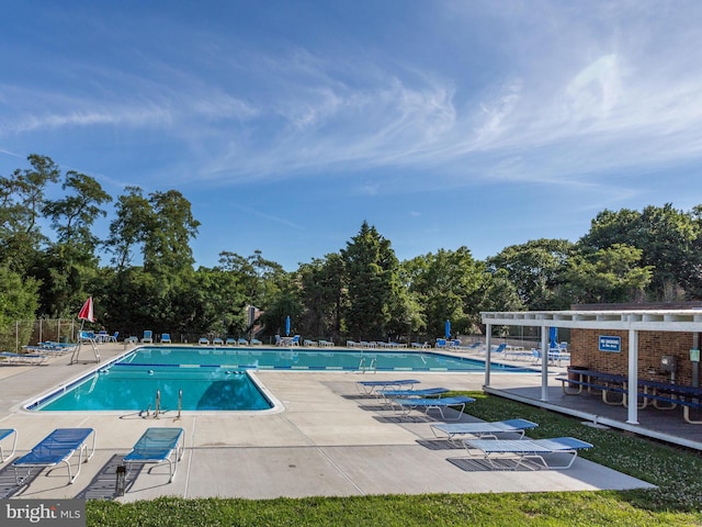 pool featuring fence, a pergola, and a patio