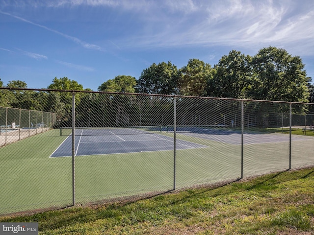 view of sport court featuring fence