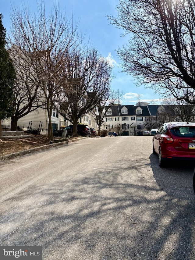 view of street featuring curbs, sidewalks, and a residential view