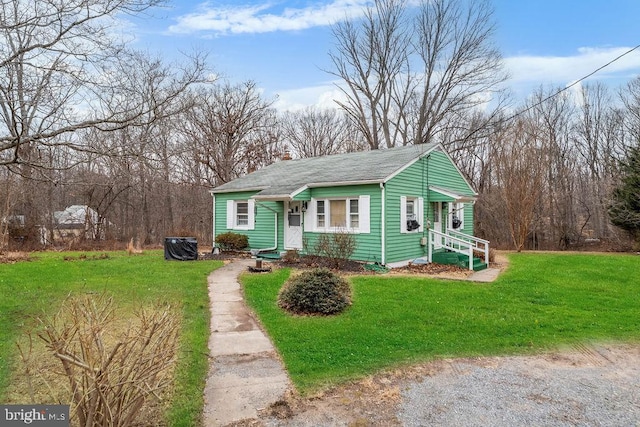 bungalow-style home featuring driveway and a front lawn