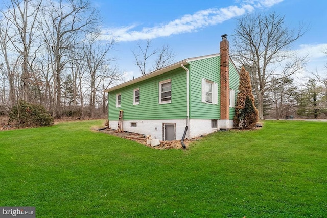 view of property exterior with a chimney and a lawn