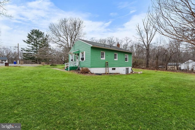 view of home's exterior with a lawn and a chimney