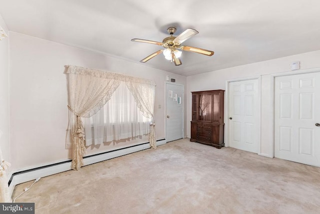 unfurnished bedroom featuring carpet, ceiling fan, and a baseboard radiator