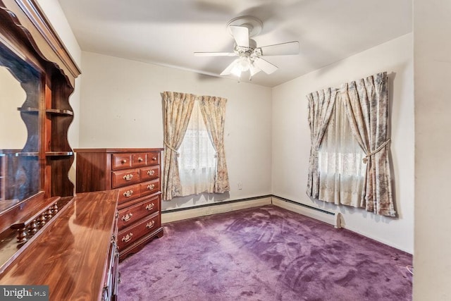 unfurnished bedroom featuring carpet, a baseboard radiator, and a ceiling fan