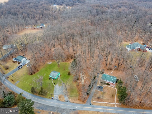 aerial view featuring a wooded view