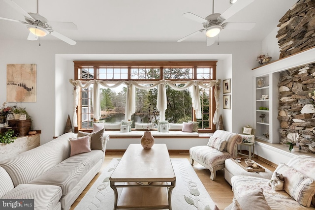 living area with ceiling fan and light wood-style flooring