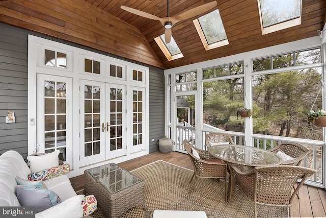 sunroom with a healthy amount of sunlight, lofted ceiling with skylight, wood ceiling, and french doors