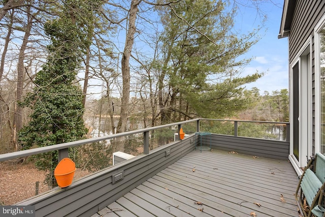 wooden terrace featuring a water view