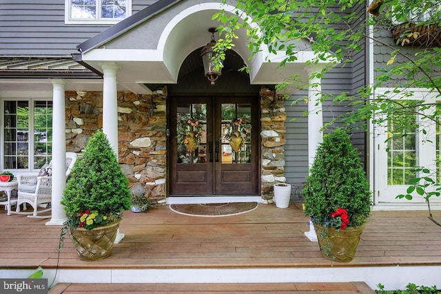 entrance to property with stone siding and french doors