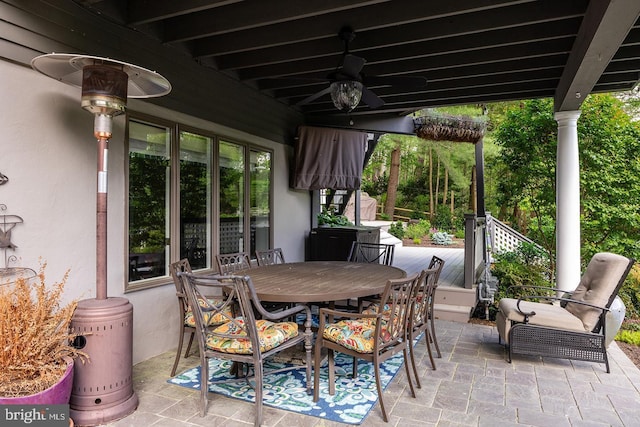 view of patio featuring outdoor dining area and a ceiling fan