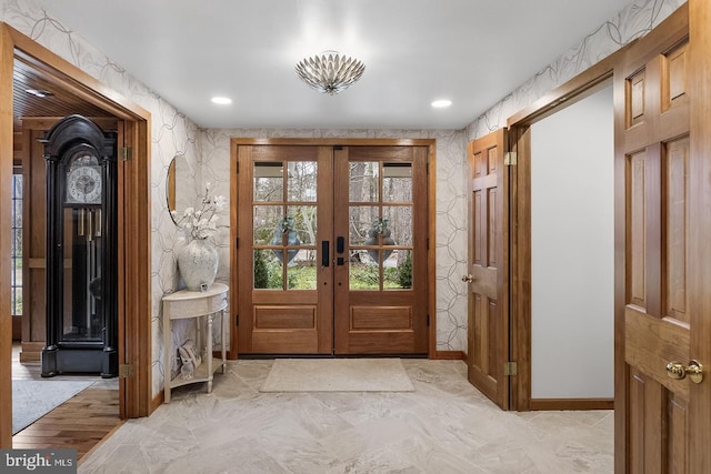 entrance foyer featuring wallpapered walls, recessed lighting, baseboards, and french doors