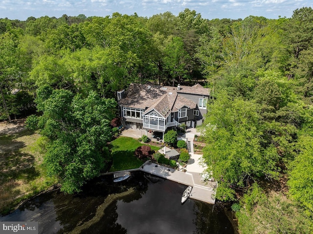 birds eye view of property featuring a water view and a forest view