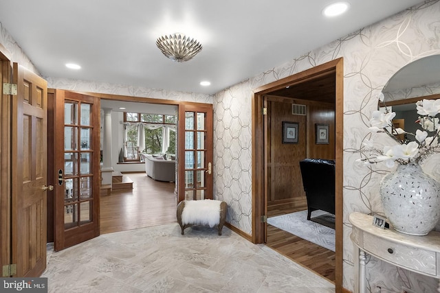 interior space with french doors, recessed lighting, light wood-style floors, and wallpapered walls