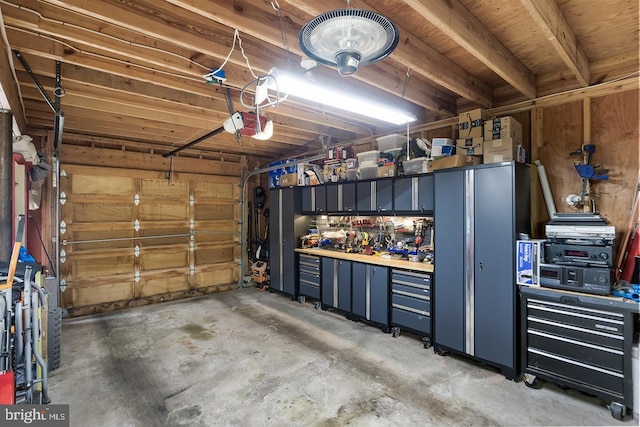 garage with a workshop area and a garage door opener