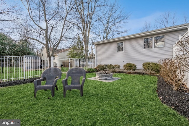 view of yard featuring an outdoor fire pit and fence