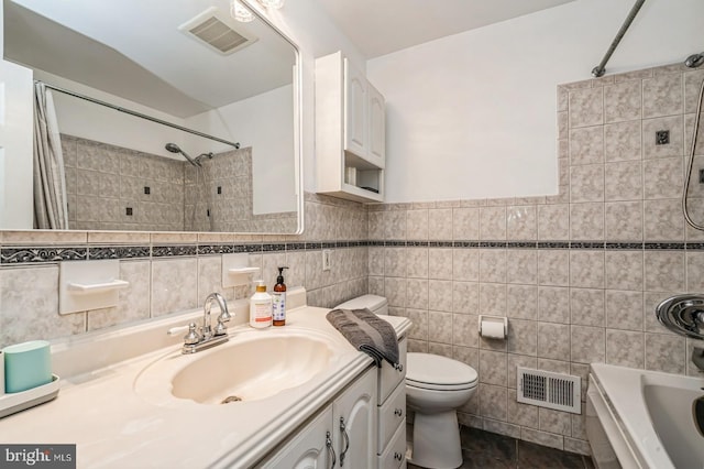 full bath featuring shower / bath combination with curtain, visible vents, vanity, and toilet