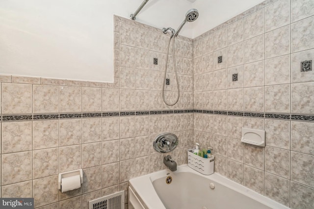 bathroom with visible vents and bathing tub / shower combination