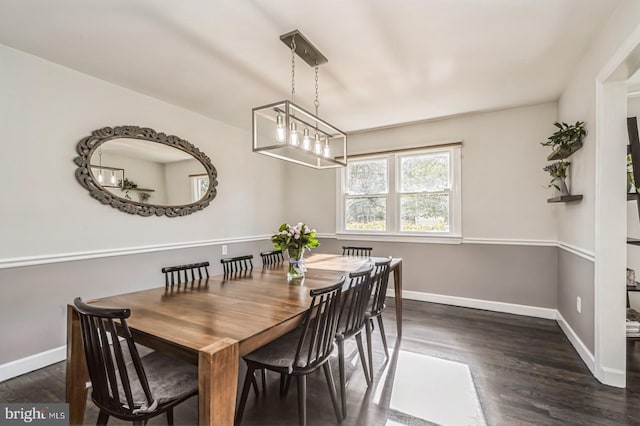 dining room featuring dark wood-style floors and baseboards