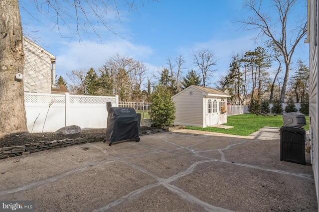 view of patio / terrace featuring a fenced backyard and an outbuilding