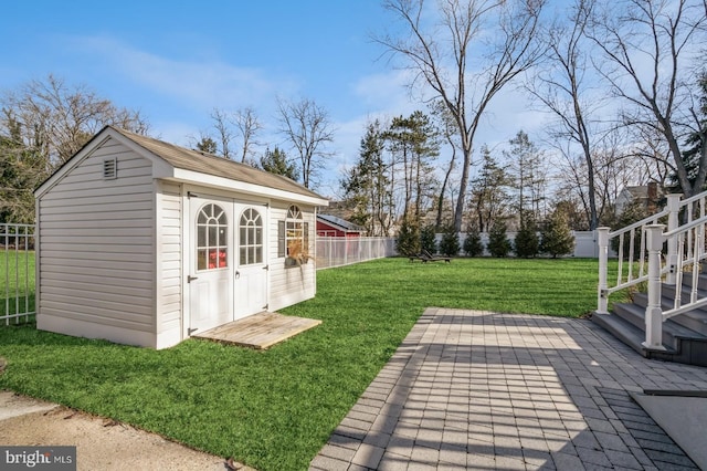 view of outdoor structure featuring an outbuilding and a fenced backyard