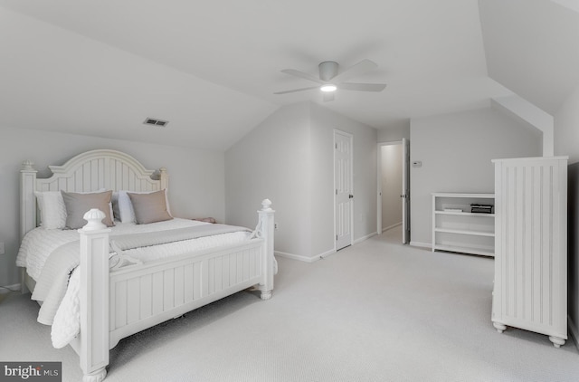 carpeted bedroom featuring visible vents, vaulted ceiling, baseboards, and ceiling fan