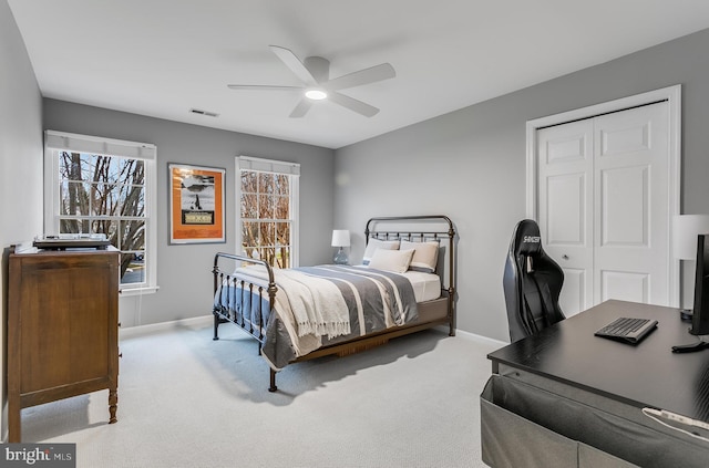 bedroom with carpet, a closet, visible vents, a ceiling fan, and baseboards