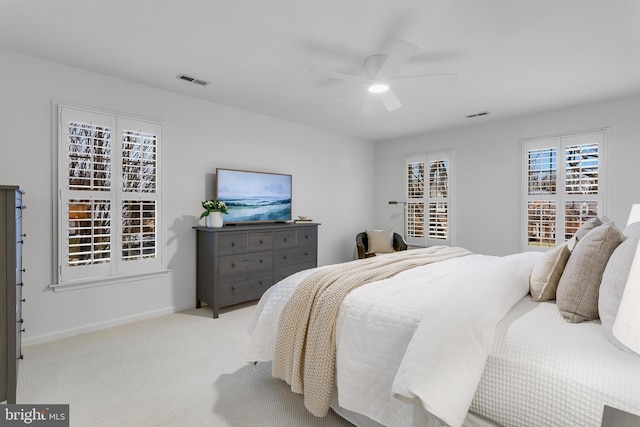 bedroom with baseboards, visible vents, ceiling fan, and carpet flooring