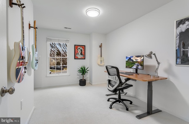 office space with carpet flooring, visible vents, and baseboards