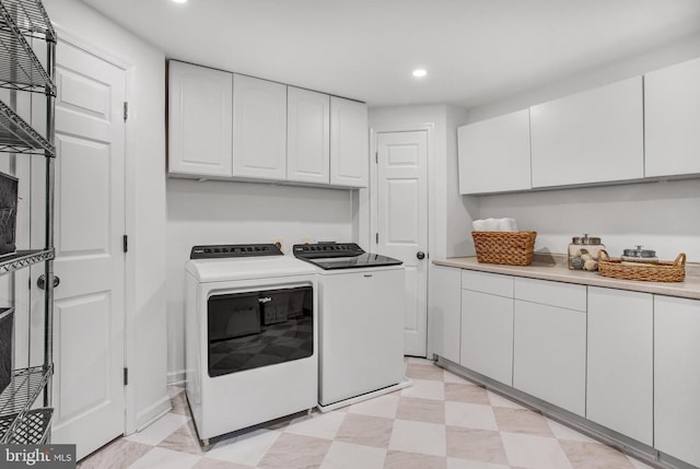 laundry room with cabinet space, recessed lighting, light floors, and washing machine and clothes dryer