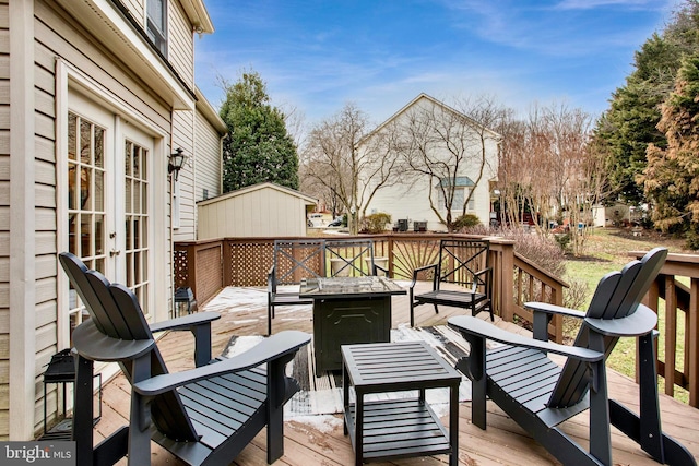 deck featuring french doors and a fire pit