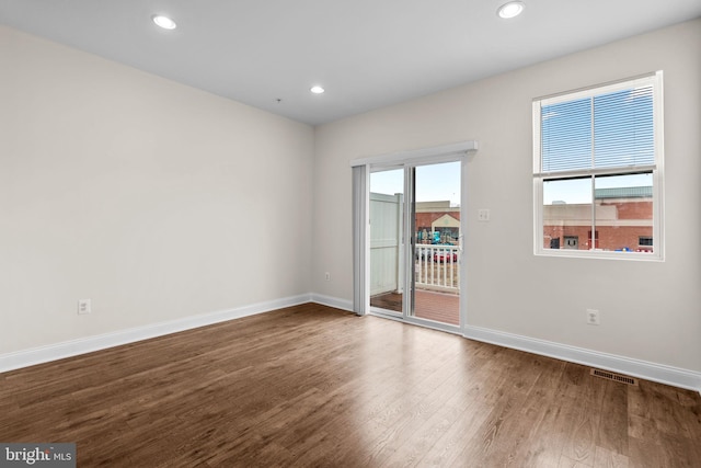 unfurnished room featuring recessed lighting, visible vents, baseboards, and wood finished floors