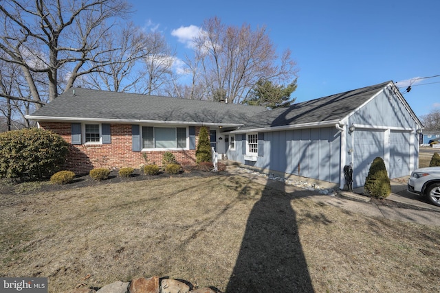 view of front facade featuring roof with shingles and brick siding