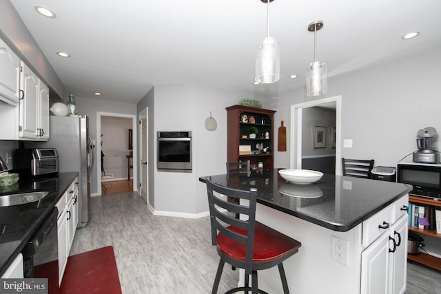 kitchen with recessed lighting, white cabinetry, a sink, and black appliances