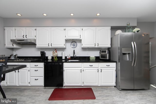 kitchen featuring gas cooktop, under cabinet range hood, a sink, black dishwasher, and stainless steel fridge with ice dispenser