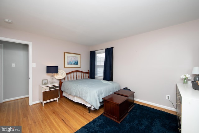 bedroom featuring light wood-style flooring and baseboards