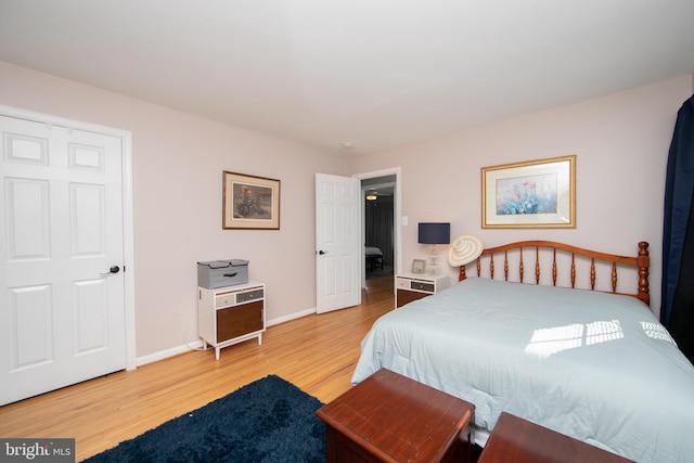 bedroom featuring baseboards and wood finished floors