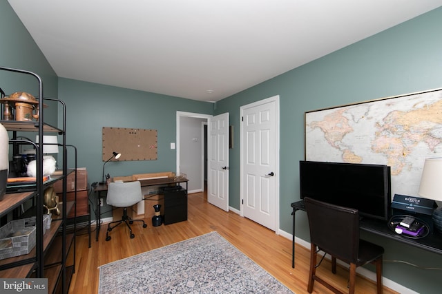 office area with wood finished floors and baseboards