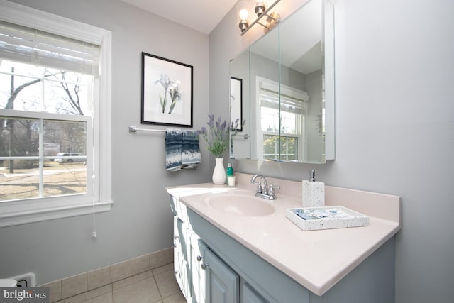 bathroom featuring tile patterned flooring, baseboards, and vanity