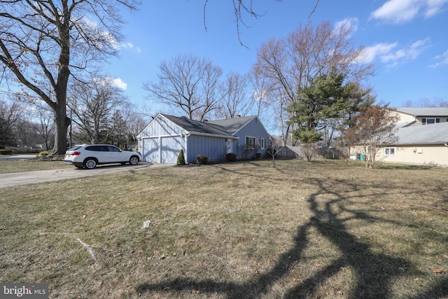 view of yard featuring a garage and driveway