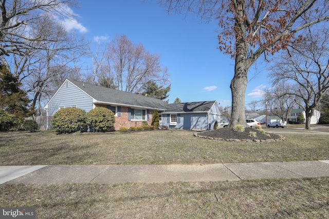 view of front of house featuring a front yard and brick siding