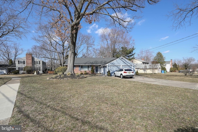 view of front facade with driveway, a front lawn, and an attached garage