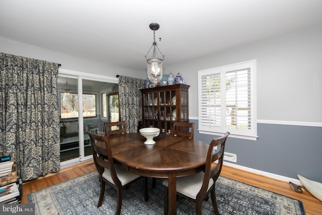 dining room featuring wood finished floors and baseboards