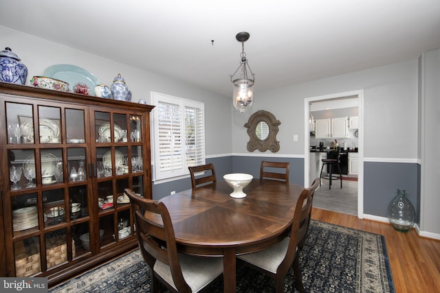 dining room with baseboards and wood finished floors