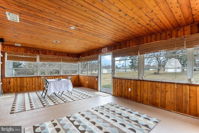 unfurnished sunroom featuring wooden ceiling, a healthy amount of sunlight, and visible vents