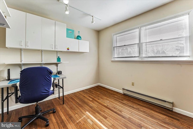 home office featuring light wood-type flooring, baseboards, a baseboard heating unit, and track lighting