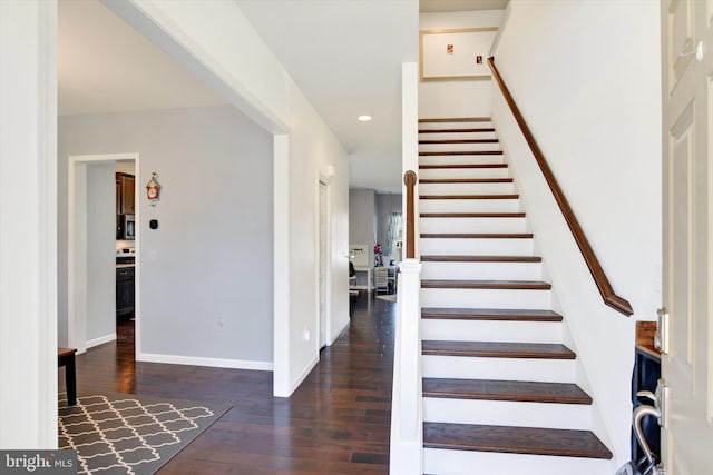 foyer with recessed lighting, dark wood-style flooring, baseboards, and stairs