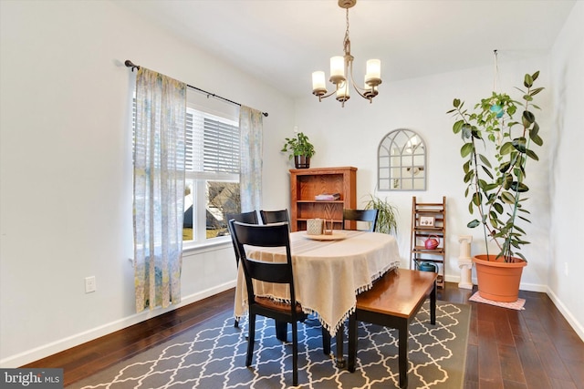 dining area with a chandelier, dark wood finished floors, and baseboards