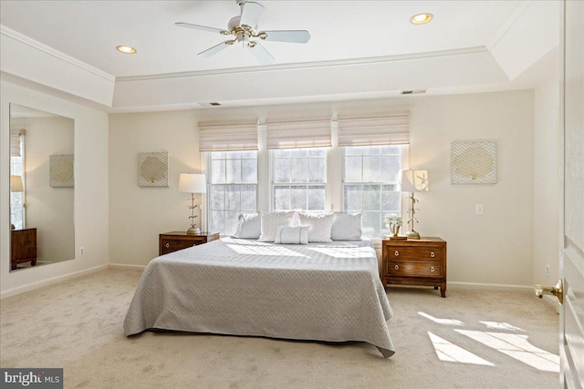 bedroom featuring ornamental molding, a raised ceiling, light carpet, and baseboards