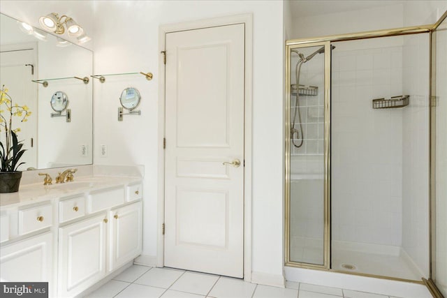 full bath with a stall shower, tile patterned flooring, and vanity