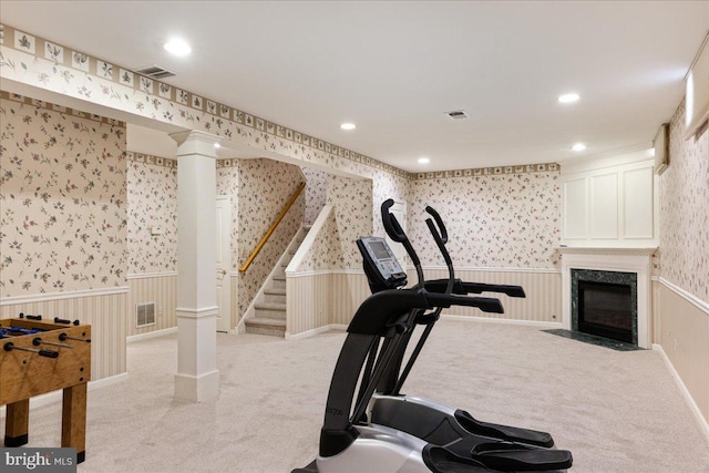 workout room featuring light colored carpet, wainscoting, and wallpapered walls